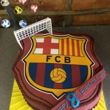 A personalised photo cake with a football badge photo on the front.