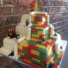 3 tiered wedding cake. The cake has icing Lego blocks. The cake is on display in a cake shop in Wolverhampton.