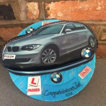 Personalised photo cake featuring a photo of a BMW. The cake is round and blue.